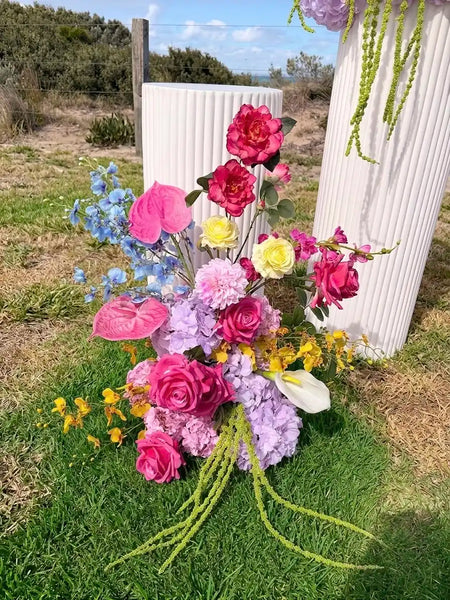 Flower cloud for a wedding in front of a white plinth on green grass in Ocean Grove