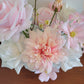 Bouquet of pink and white flowers against a wooden bench