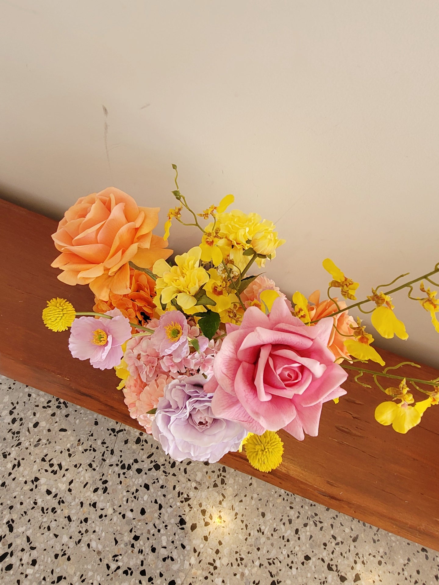Bouquet of flowers on a wooden surface with a light background