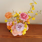 Colorful flower arrangement on a wooden surface with a neutral background