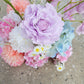 Pastel-colored flowers on a concrete surface