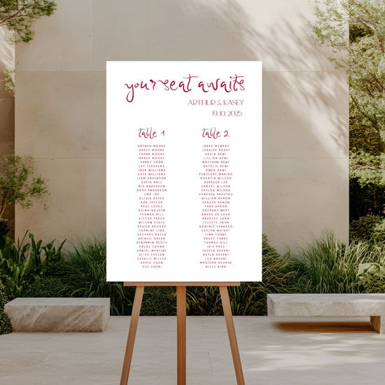 Seating chart on an easel outdoors with a garden background