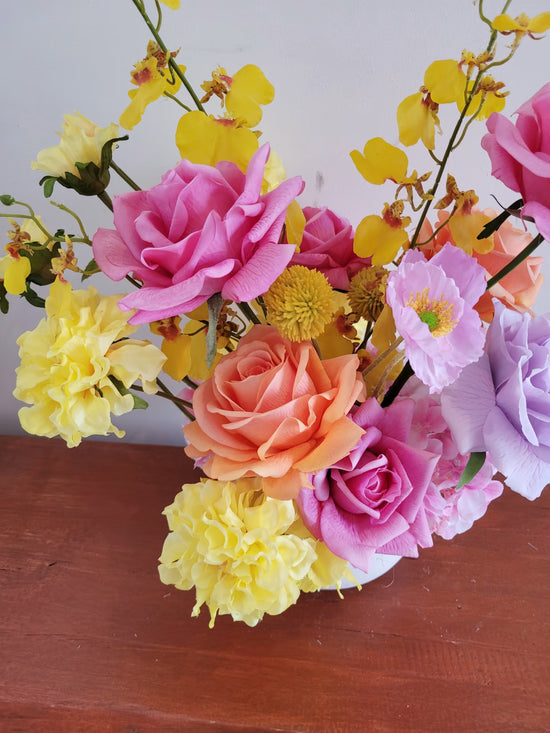 Close up of bright flowers, especially pink and orange roses