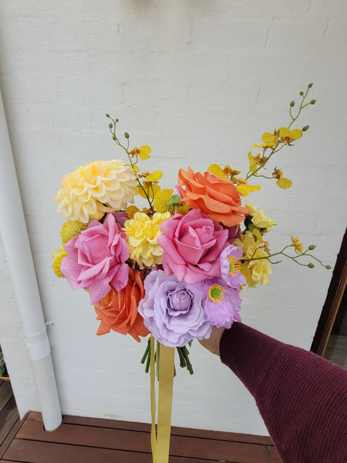 Bright bridal bouquet with yellow, pink, orange and lilac flowers