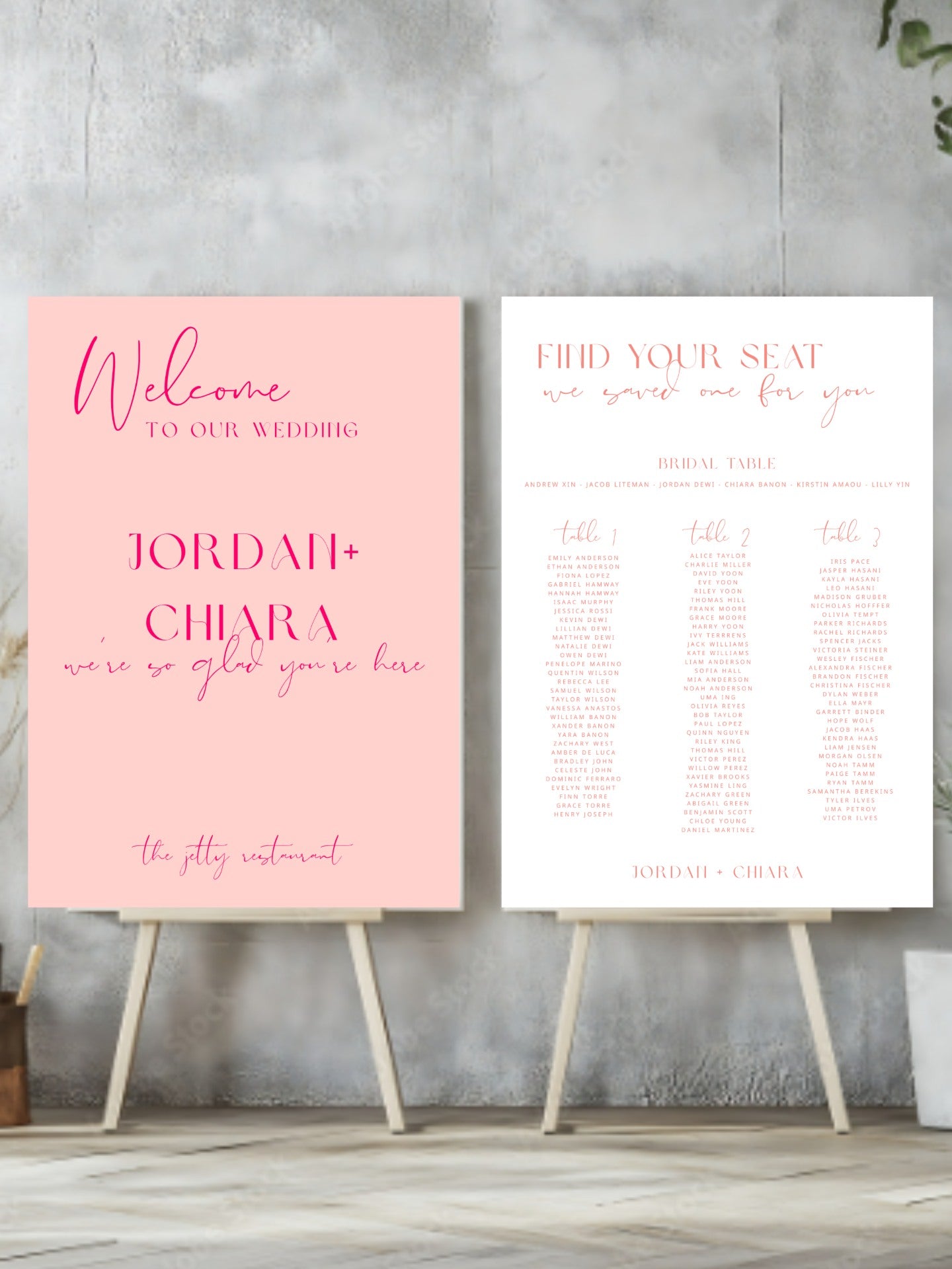 Two wedding signs on stands against a gray concrete wall.