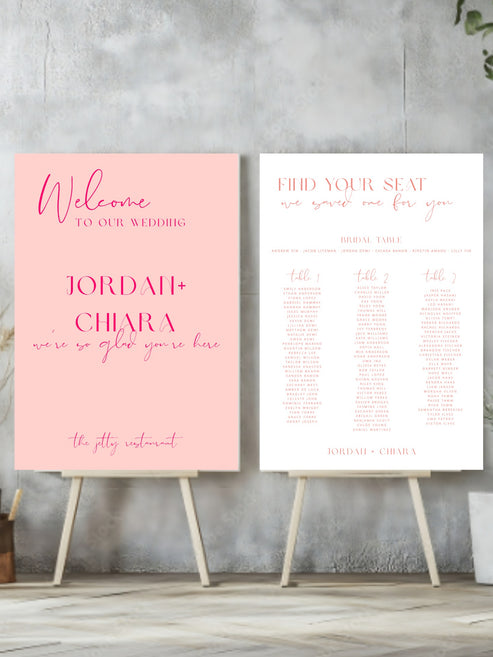 Two wedding signs on stands against a gray concrete wall.