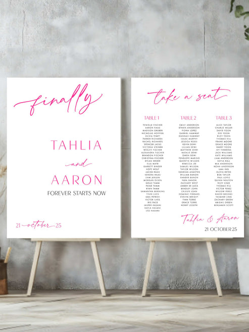 welcome sign and seating charts on easels with decorative text against a concrete wall.