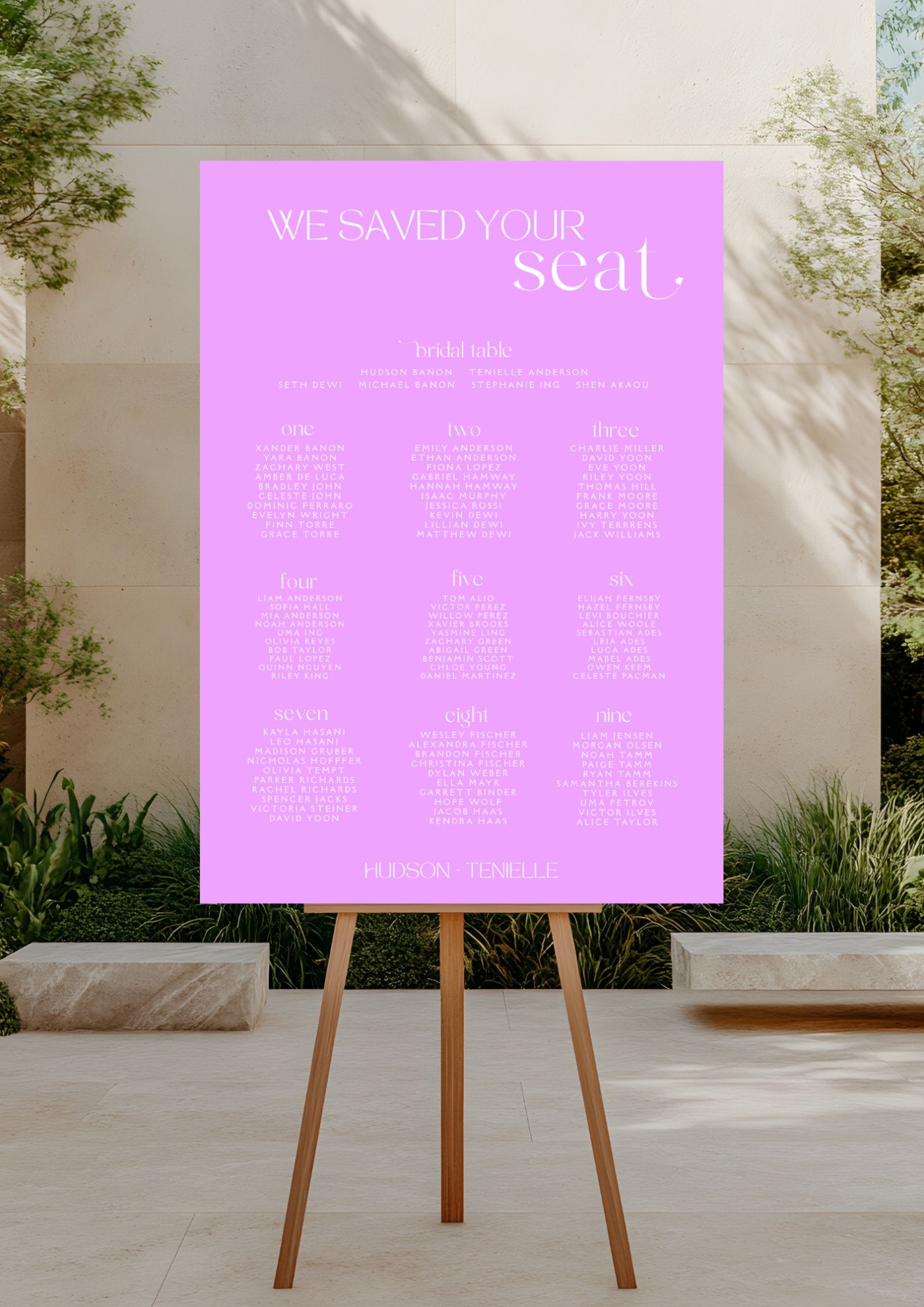 Purple seating chart poster on an easel outdoors