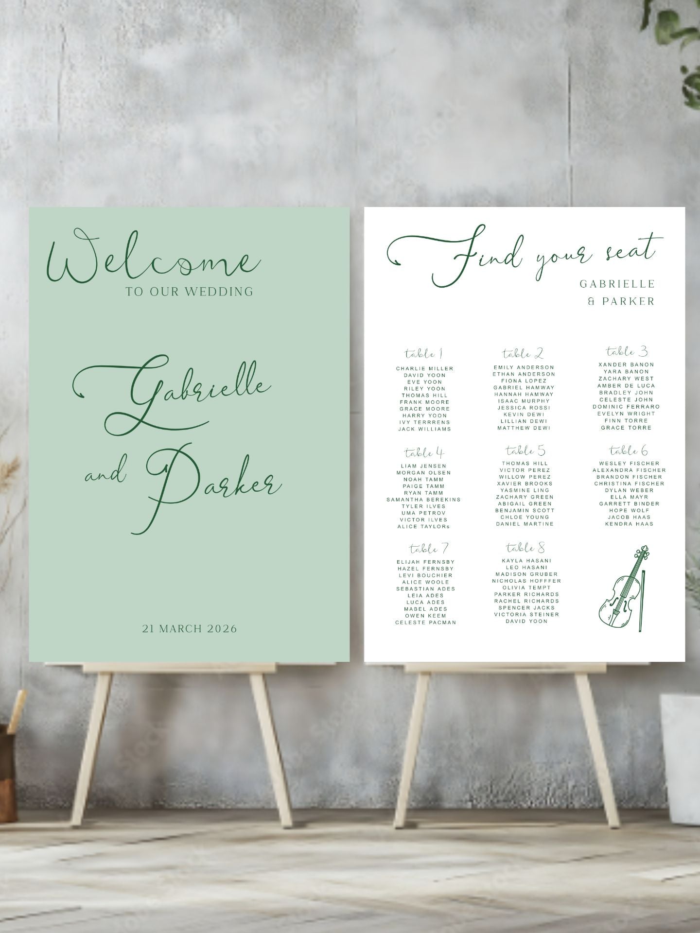 Two wedding signs on stands against a gray concrete wall.