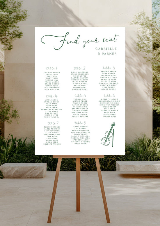 Seating chart on an easel outdoors with a garden background