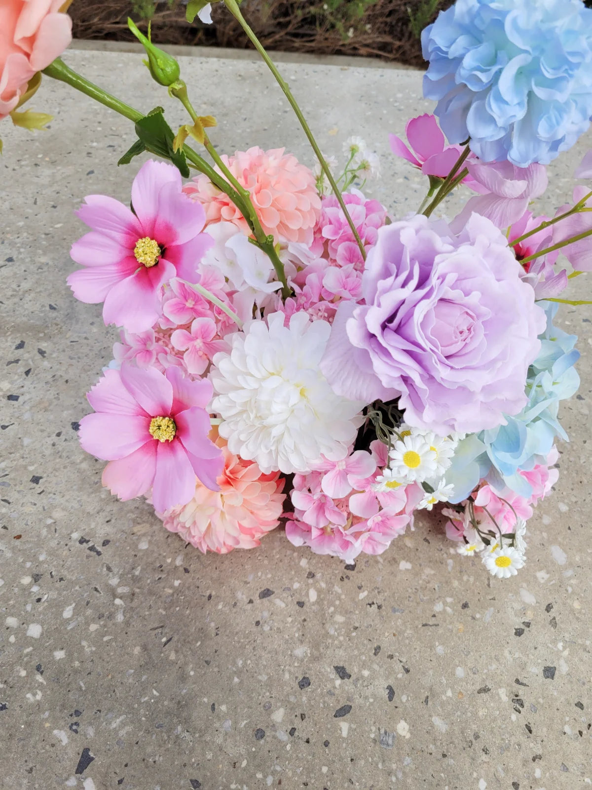 Colorful flower arrangement on a concrete surface