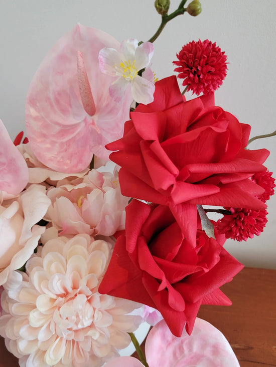Close up of red artificial roses that are made from real-touch materials