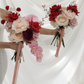 Two floral bouquets held by a person against a white curtain
