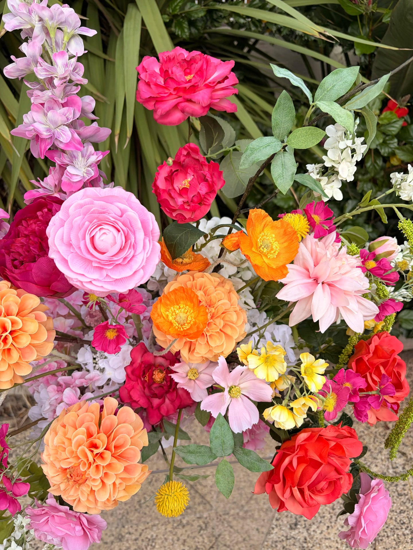 Close up of whimsical pink and orange faux wedding flowers