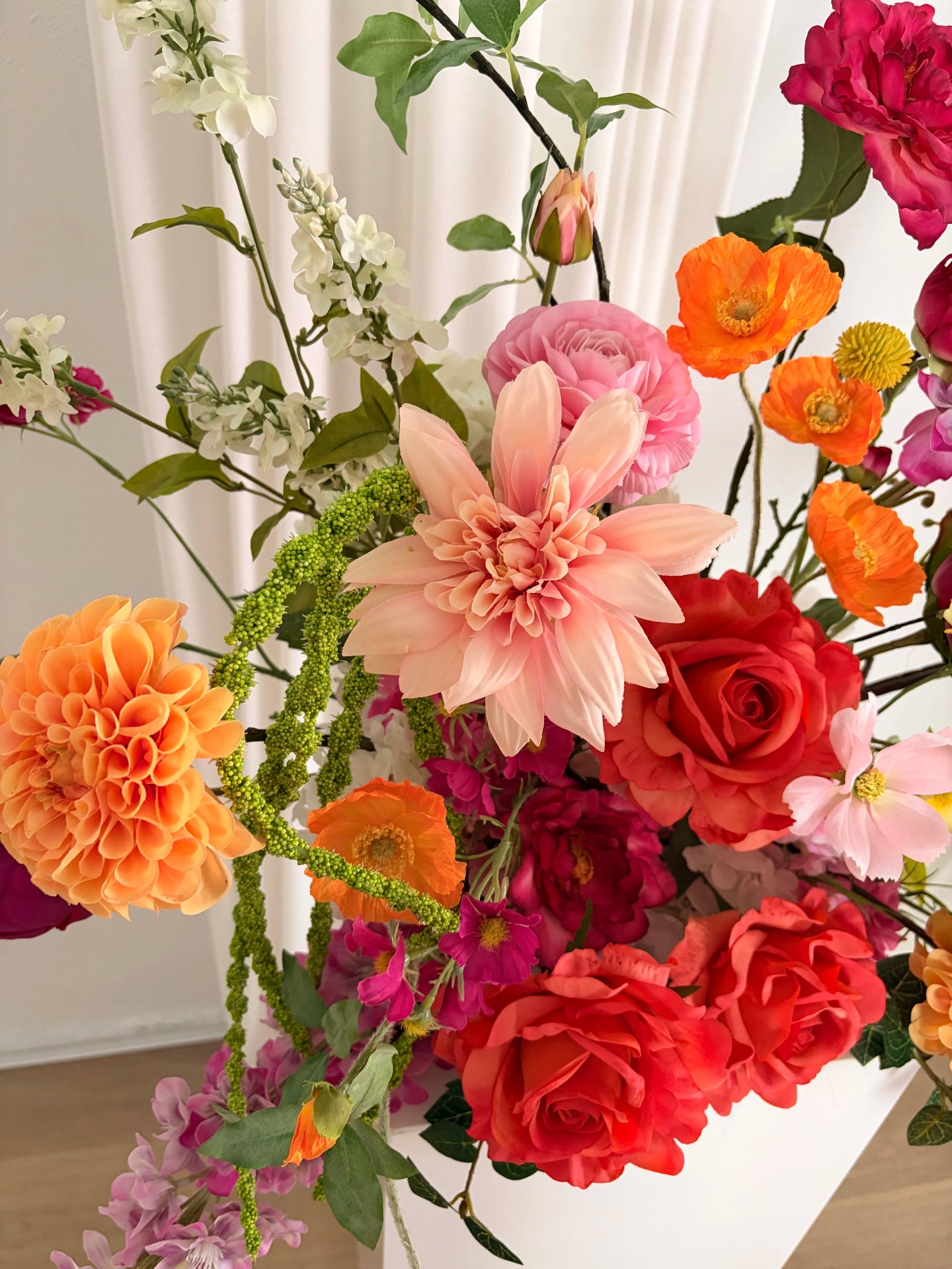 Close up of an artificial flower arrangement with a beautiful pink dahlia