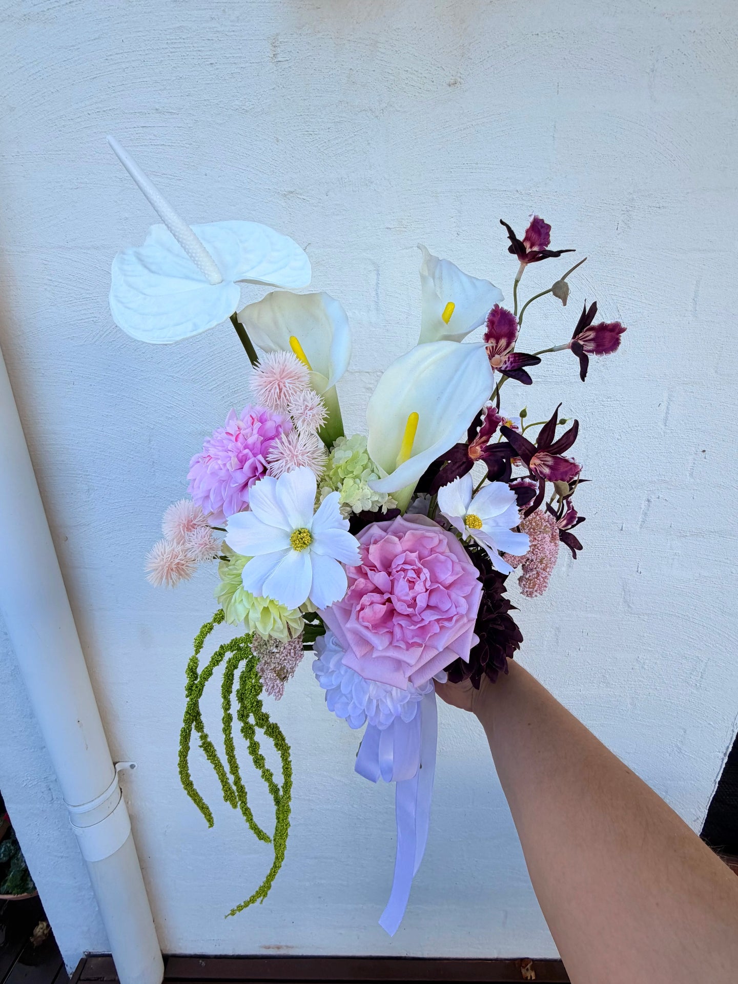 Modern bridal bouquet with calla lilies and anthurium in pink, white and burgundy