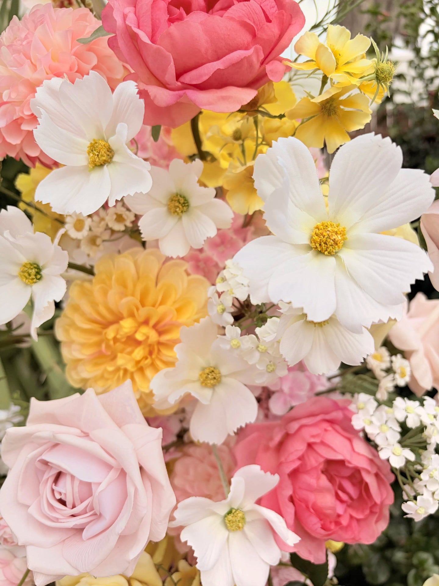 Close up of artificial cosmos forming part of an arbour artificial flower arrangement