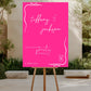 Pink wedding sign on an easel outdoors