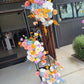 Colourful floral arrangements in front of a building entrance