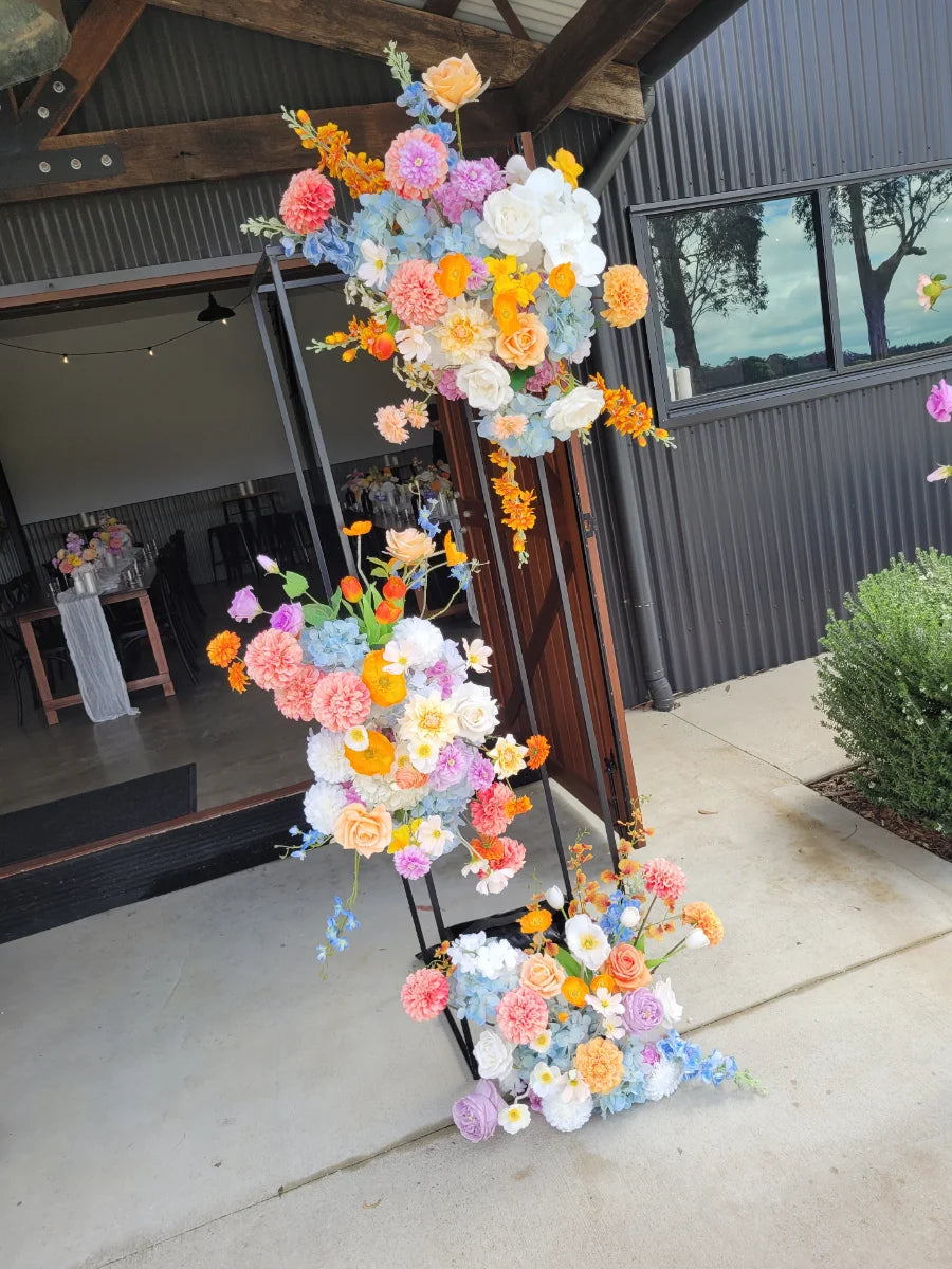 Colourful floral arrangements in front of a building entrance