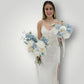 Woman in a white wedding dress holding multiple wedding bouquets against a plain background