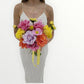 Woman holding a colorful bridal bouquet of flowers against a white background