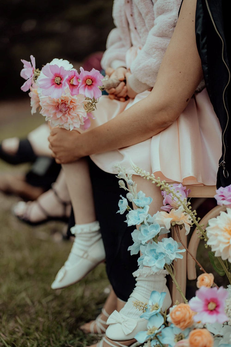 Child holding a bouquet of flowers with a blurred background
