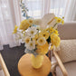 Floral arrangement with yellow and blue on a side table in a living room