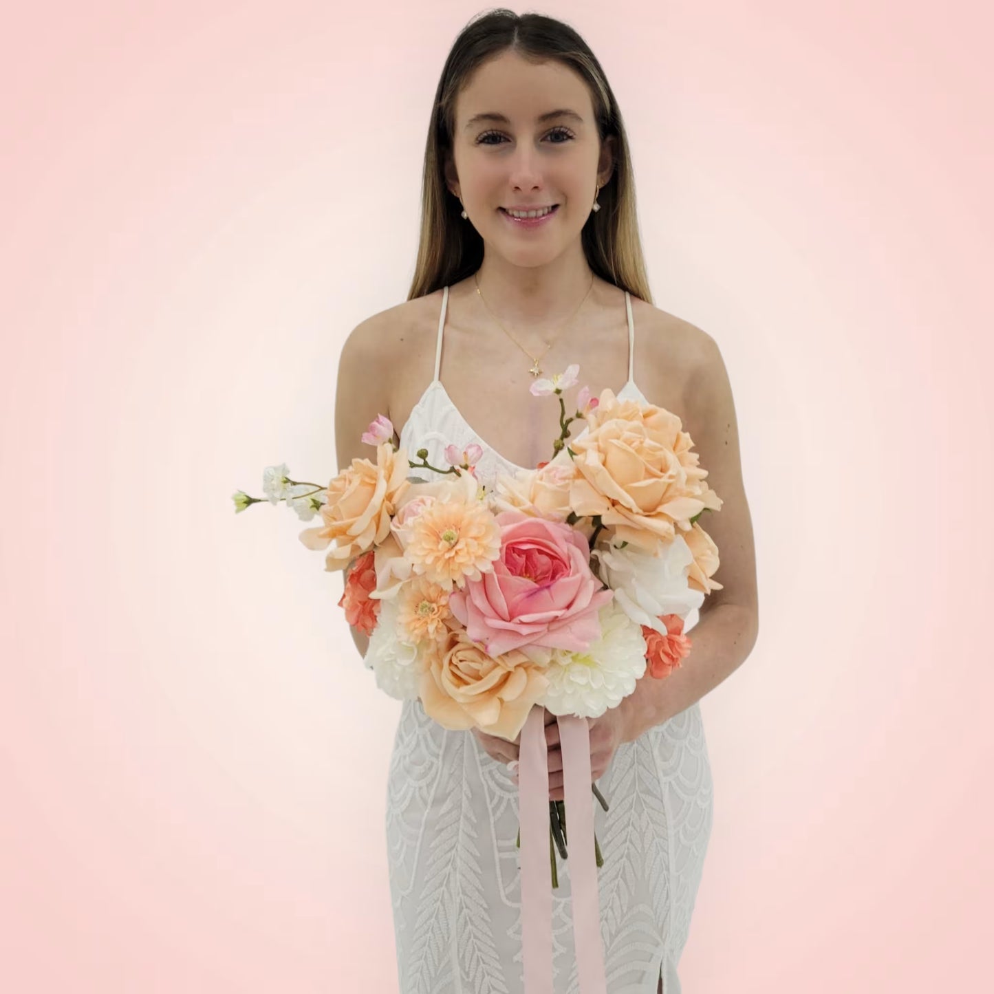 Woman holding a bouquet of flowers against a pink background