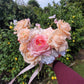 Bridal bouquet held by a person against a green garden background