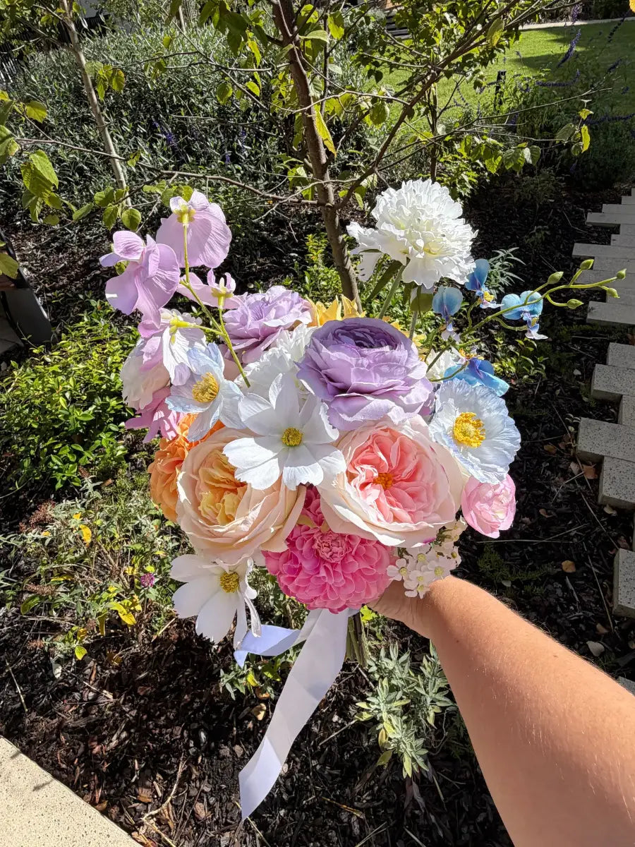 Colourful wedding bouquet held by a person outdoors