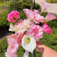 Hand holding a bridal pink calla lily wedding bouquet