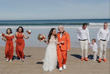 Wedding party on a beach with terracotta faux bouquets with ocean view